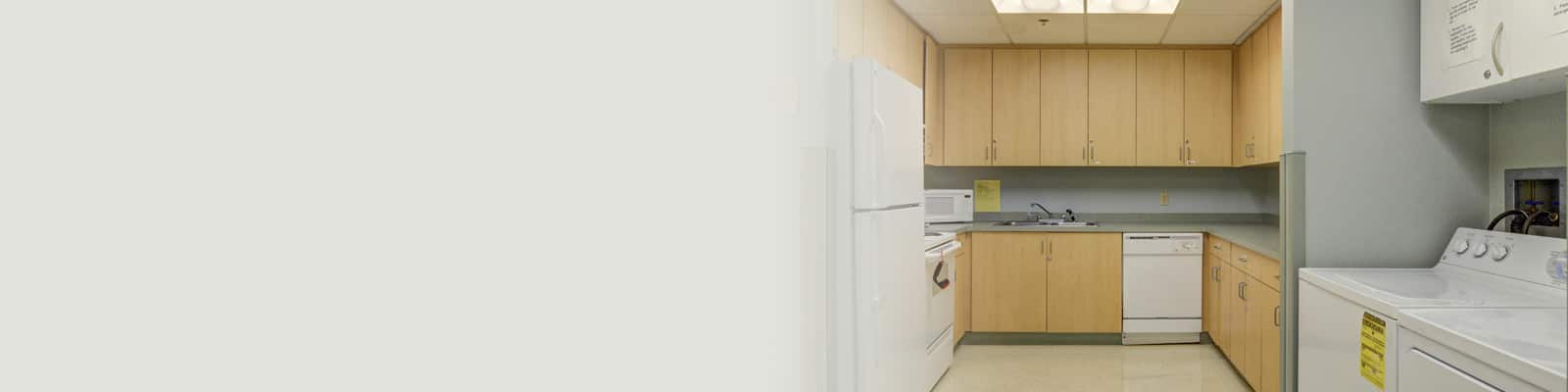 A small kitchen and washing machine at Ivy Park